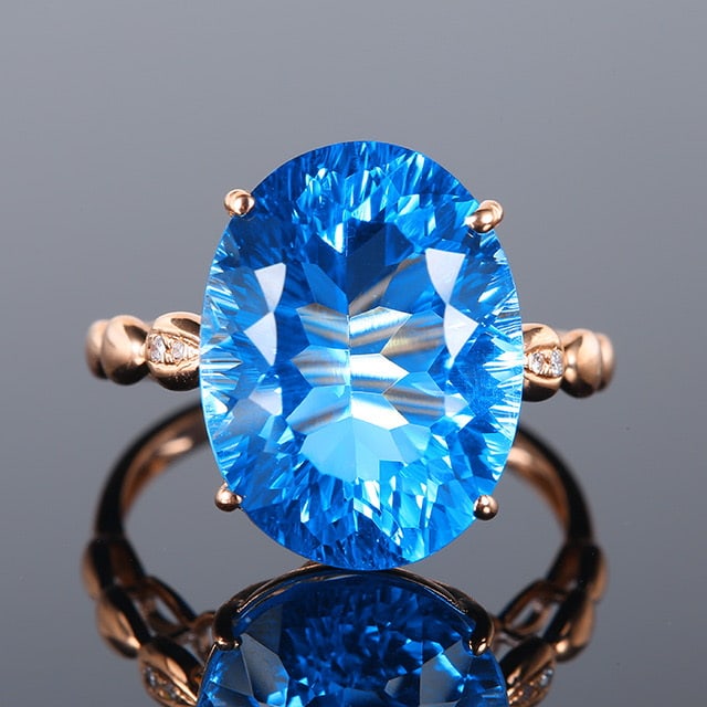 14k Gold 11.56 Ctw Natural Topaz & Diamond Ring: Ref:231018052 // gold content:14k gold // ring size:7. 25us // // main gemstone:topaz // shape:oval // carat weight:11. 55ct // color:blue // treatment:natural // // adjacent gemstone 2 : diamond //
