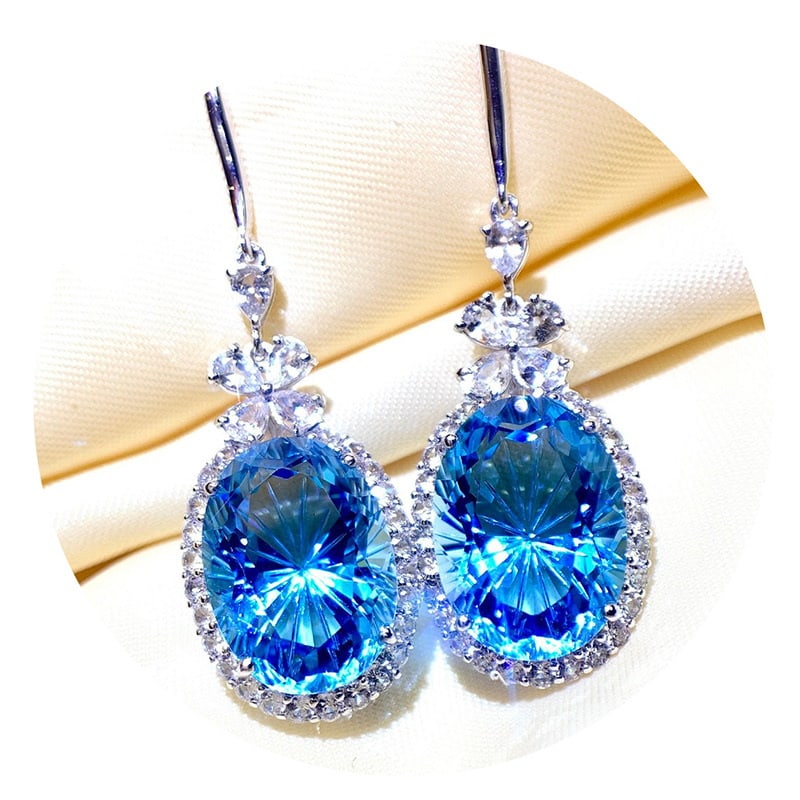 14k Gold 14.3 Ct Natural Topaz & Sapphire Earrings: Ref:231018054 // gold content:14k gold // main gemstone:topaz // shape:oval // carat weight:14. 3ct // color:blue // treatment:natural // // adjacent gemstone 2 : sapphire // number of stones:60 //