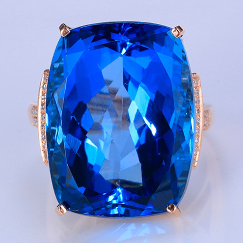14k Gold 30.40 Ctw Natural Topaz & Diamond Ring: Ref:231018148 // gold content:14k gold // ring size:7. 25us // // main gemstone:topaz // shape:cushion // carat weight:30. 3ct // color:blue // treatment:natural // // adjacent gemstone 2 : diamond