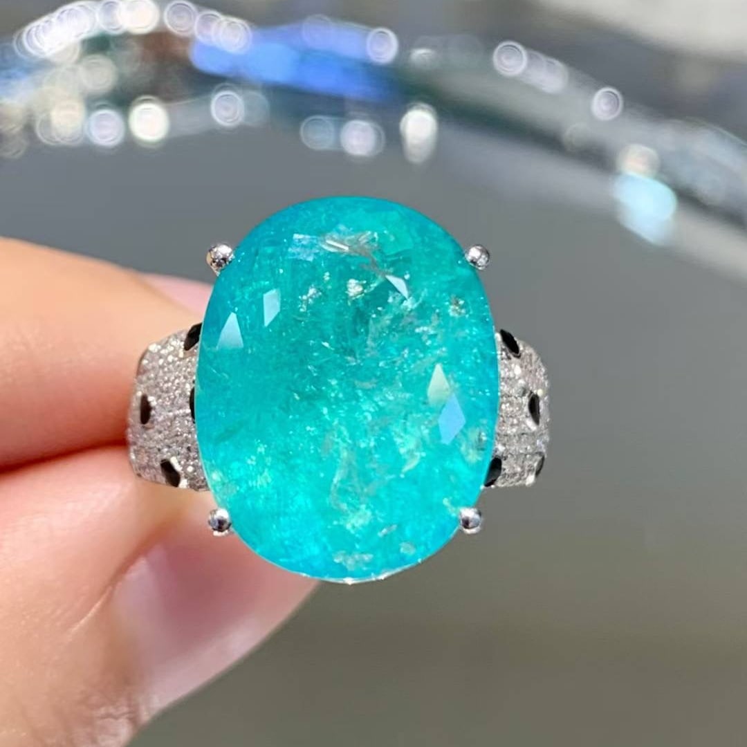 14k Gold 10.39 Ct Natural Paraiba Tourmaline & Diamond Ring: Ref:231018192 // gold content:14k gold // ring size:7. 25us // // main gemstone:paraiba tourmaline // shape:oval // carat weight:10. 39ct // color:blue // treatment:natural // // adjacent gemstone 2