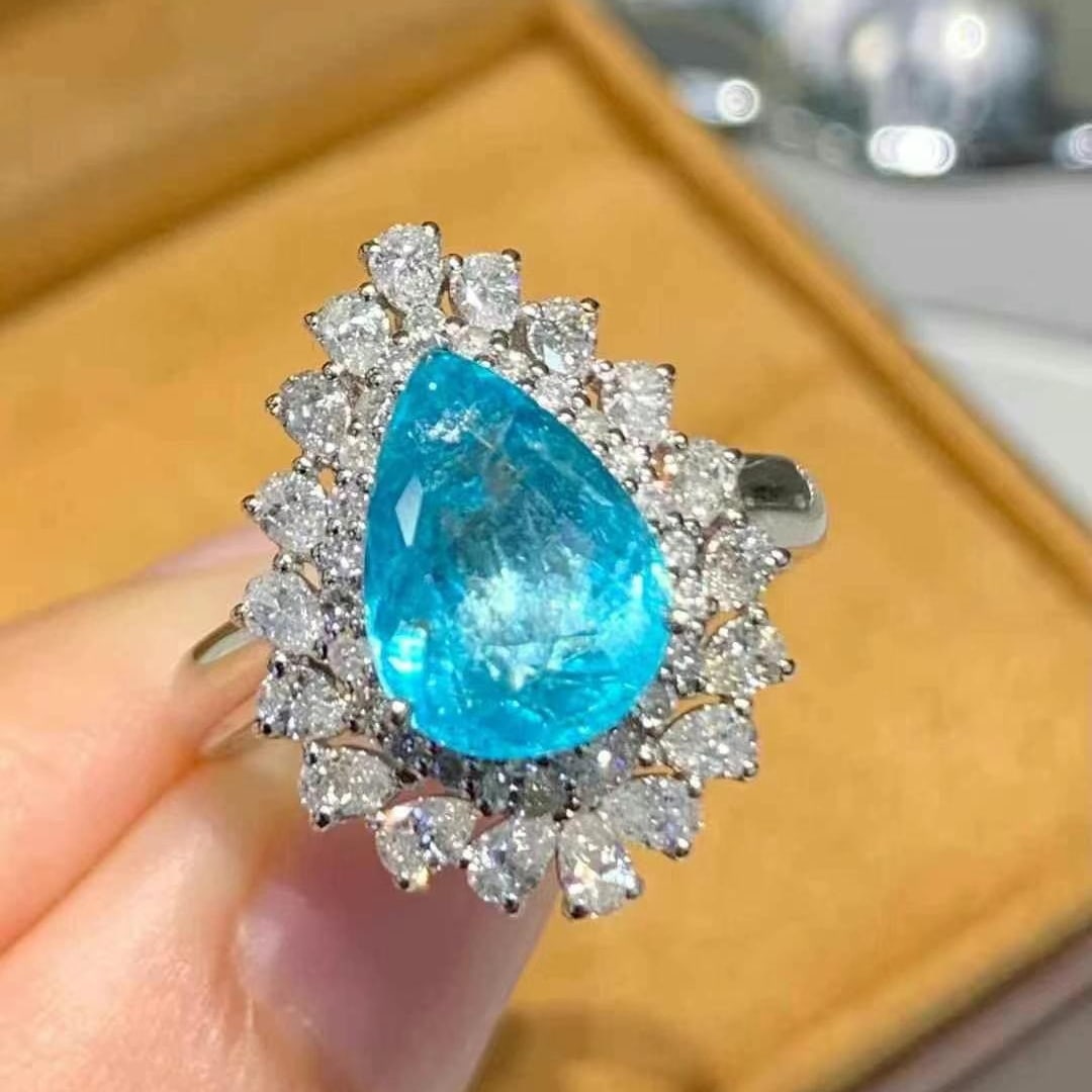 14k Gold 2.81 Ct Natural Paraiba Tourmaline & Diamond Ring: Ref:231018290 // gold content:14k gold // ring size:7. 25us // // main gemstone:paraiba tourmaline // shape:pear // carat weight:2. 81ct // color:blue // treatment:natural // // adjacent gemstone 2 :