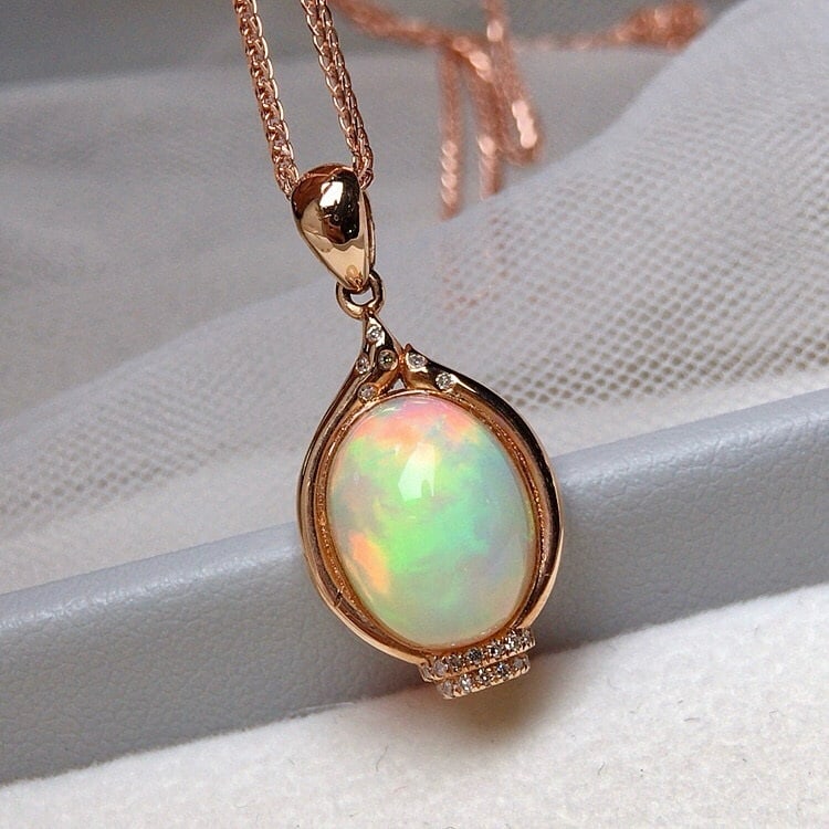 14k Gold 3.5 Ct Natural Opal & Diamond Pendant( Without Chain ): Ref:231019003 // gold content:14k gold // main gemstone:opal // shape:oval // carat weight:3. 5ct // color:white // treatment:natural // // adjacent gemstone 2 : diamond // number of stones:20 //