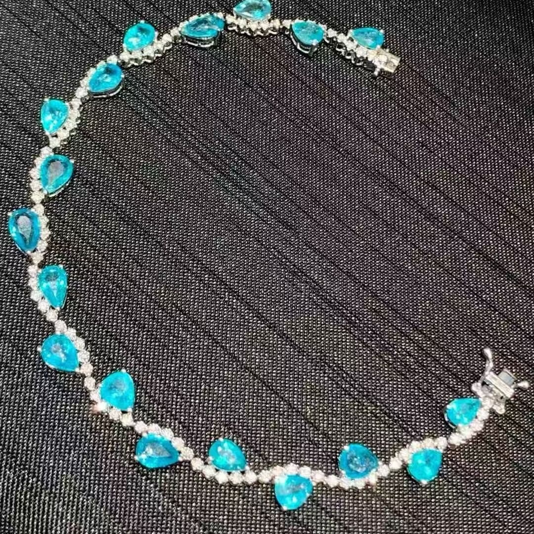 14k Gold 6.5 Ct Natural Paraiba Tourmaline & Diamond Bracelet: Ref:231019091 // gold content:14k gold // main gemstone:paraiba tourmaline // shape:pear // carat weight:6. 5ct // color:neon blue // treatment:natural // // adjacent gemstone 2 : diamond //