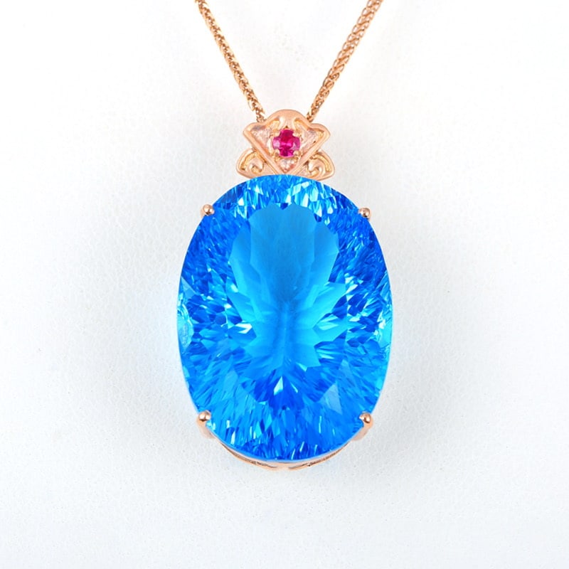 14k Gold 46.38 Ct Natural Topaz & Ruby Pendant( Without Chain ): Ref:231020012 // gold content:14k gold // main gemstone:topaz // shape:oval // carat weight:46. 38ct // color:blue // treatment:natural // // adjacent gemstone 2 : ruby // number of stones:1 //