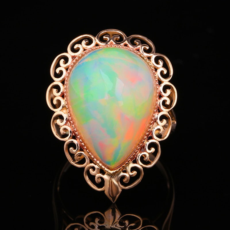 14k Gold 10.60 Ct Natural Opal Ring: Ref:231020027 // gold content:14k gold // ring size:7. 25us // // main gemstone:opal // shape:pear // carat weight:10. 60ct // color:color // treatment:natural // High Estimate: 4300 Condition: New Lo