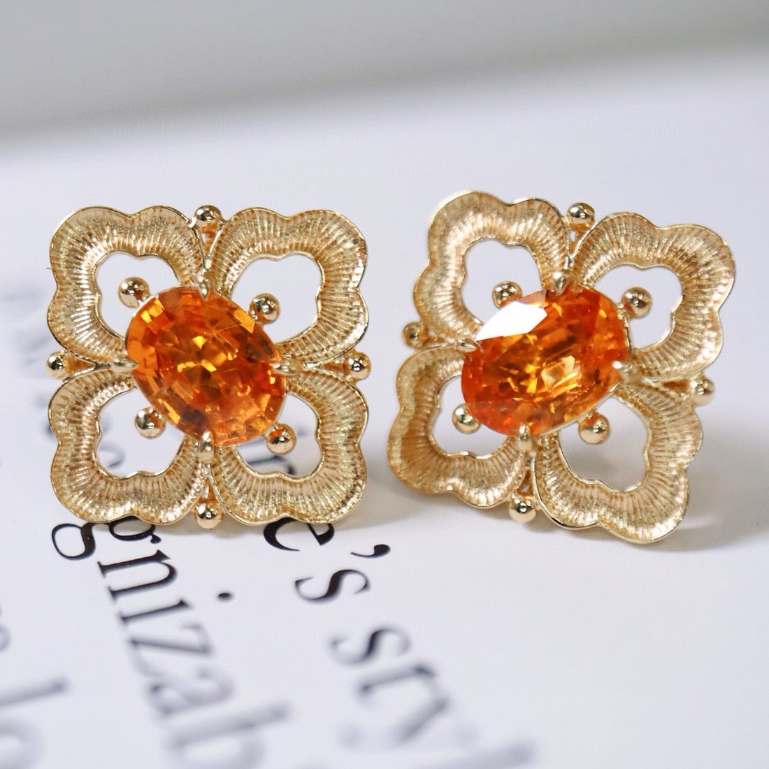 14k Gold 2.68 Ct Natural Spessartine Earrings: Ref:231020116 // gold content:14k gold // main gemstone:spessartine // shape:oval // carat weight:2. 68ct // color:orange // treatment:natural // Condition: New Low Estimate: 6400 High Estimate: 9600