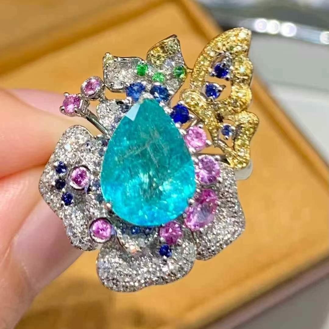 14k Gold 3.2 Ct Natural Paraiba Tourmaline & Diamond Ring: Ref:231020276 // gold content:14k gold // ring size:7. 25us // // main gemstone:paraiba tourmaline // shape:pear // carat weight:3. 2ct // color:blue // treatment:natural // // adjacent gemstone 2 :
