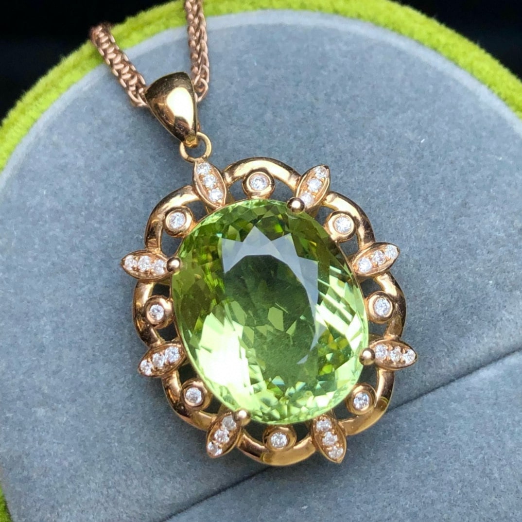 14k Gold 11.7 Ct Natural Tourmaline & Diamond Pendant( Without Chain ): Ref:231020282 // gold content:14k gold // main gemstone:tourmaline // shape:oval // carat weight:11. 7ct // color:green // treatment:natural // // adjacent gemstone 2 : diamond // number of stones:32