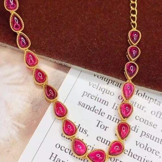 14k Gold 15.62 Ct Natural Tourmaline Bracelet: Ref:231020285 // gold content:14k gold // main gemstone:tourmaline // shape:pear // carat weight:15. 62ct // color:red // treatment:natural // Condition: New Low Estimate: 7300 High Estimate: 11000