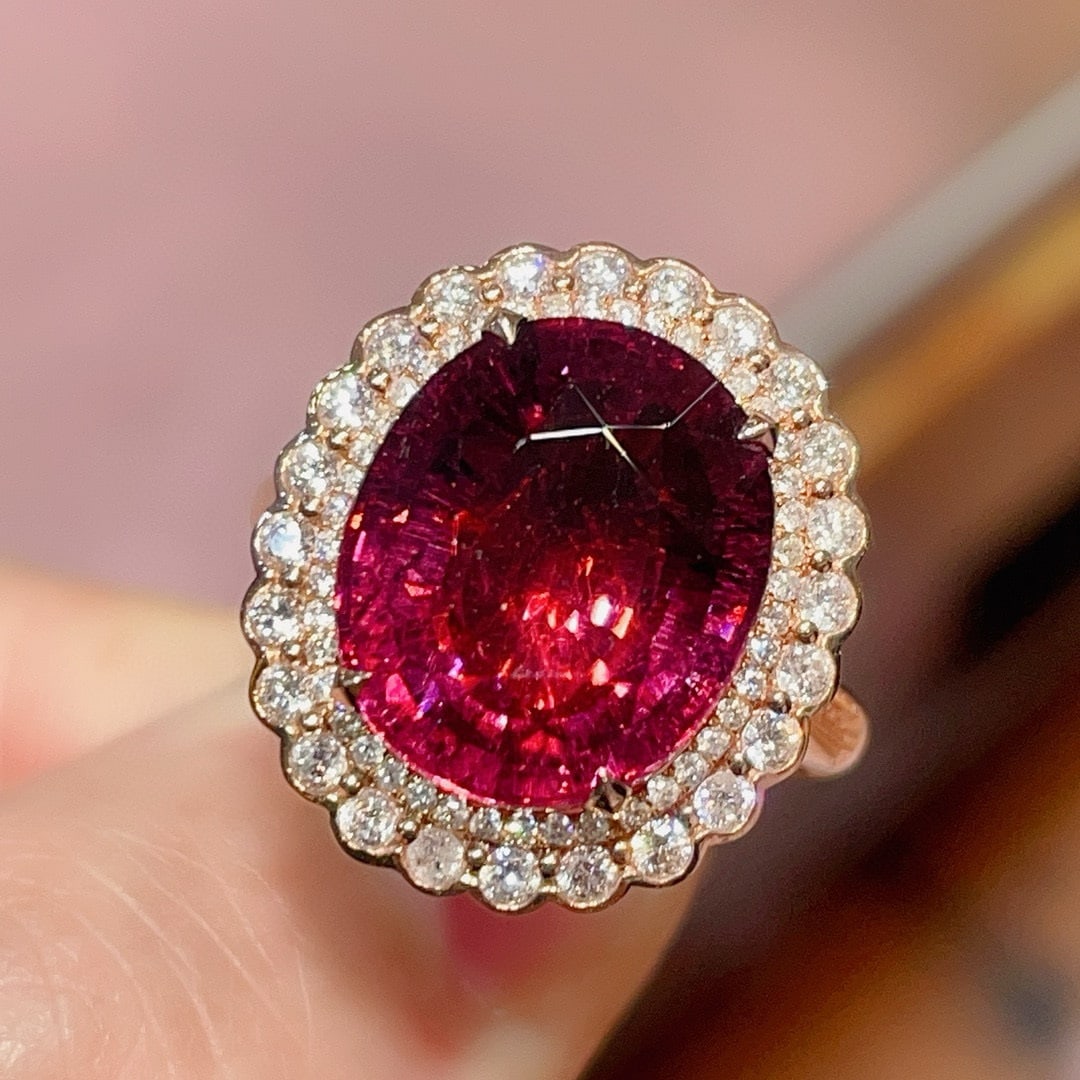 14k Gold 8.45 Ctw Natural Tourmaline & Diamond Ring: Ref:231020319 // gold content:14k gold // ring size:7. 25us // // main gemstone:tourmaline // shape:oval // carat weight:7. 81ct // color:red // treatment:natural // // adjacent gemstone 2 : diamond /