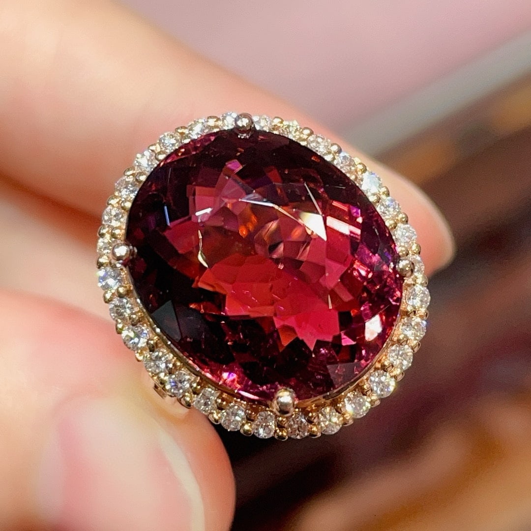 14k Gold 15.3 Ct Natural Tourmaline & Diamond Ring: Ref:231020369 // gold content:14k gold // ring size:7. 25us // // main gemstone:tourmaline // shape:oval // carat weight:15. 3ct // color:red // treatment:natural // // adjacent gemstone 2 : diamond /