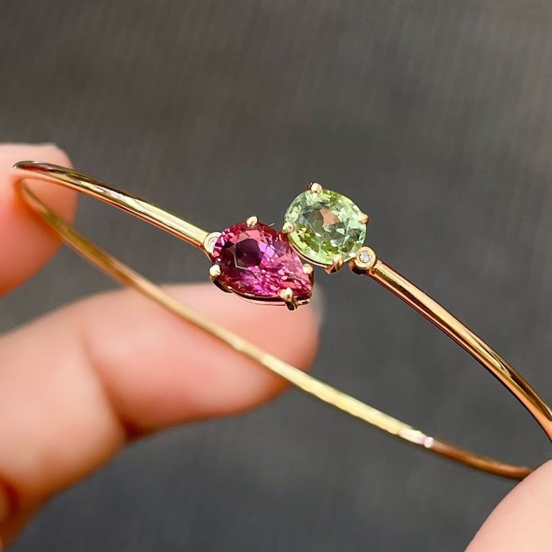 14k Gold 2.34 Ct Natural Tourmaline & Diamond Bangle: Ref:231029247 // gold content:14k gold // main gemstone:tourmaline // shape:oval // carat weight:2. 34ct // color:pink // treatment:natural // cut grade:g // // adjacent gemstone 2 : diamond //