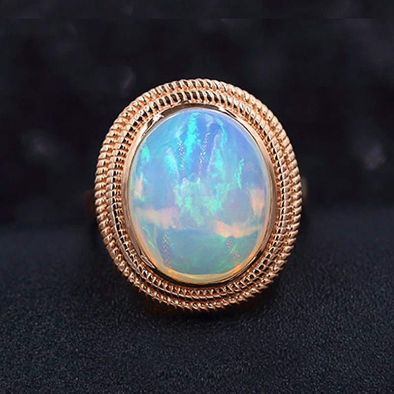 14k Gold 6.65 Ct Natural Opal Ring: Ref:231030062 // gold content:14k gold // ring size:7. 25us // // main gemstone:opal // shape:oval // carat weight:6. 65ct // color:color // treatment:natural // Low Estimate: 2400 Condition: New High
