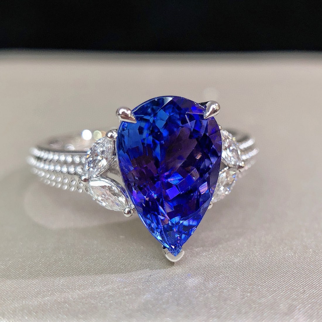 14k Gold 3.29 Ctw Natural Tanzanite & Diamond Ring: Ref:231030126 // gold content:14k gold // ring size:7. 25us // // main gemstone:tanzanite // shape:pear // carat weight:3. 10ct // color:blue // treatment:natural // // adjacent gemstone 2 : diamond