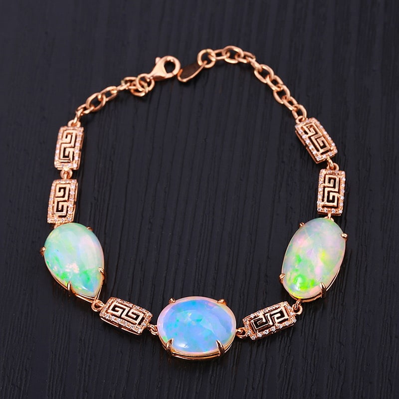14k Gold 21.50 Ctw Natural Opal & Diamond Bracelet: Ref:231030154 // gold content:14k gold // main gemstone:opal // shape:oval // carat weight:21. 18ct // color:color // treatment:natural // // adjacent gemstone 2 : diamond // shape:round // carat