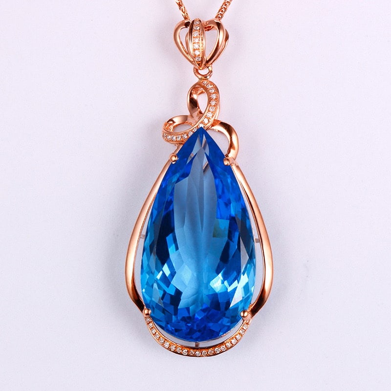 14k Gold 35.13 Ctw Natural Topaz & Diamond Pendant( Without Chain ): Ref:231030195 // gold content:14k gold // main gemstone:topaz // shape:pear // carat weight:35. 00ct // color:blue // treatment:natural // // adjacent gemstone 2 : diamond // shape:round // carat