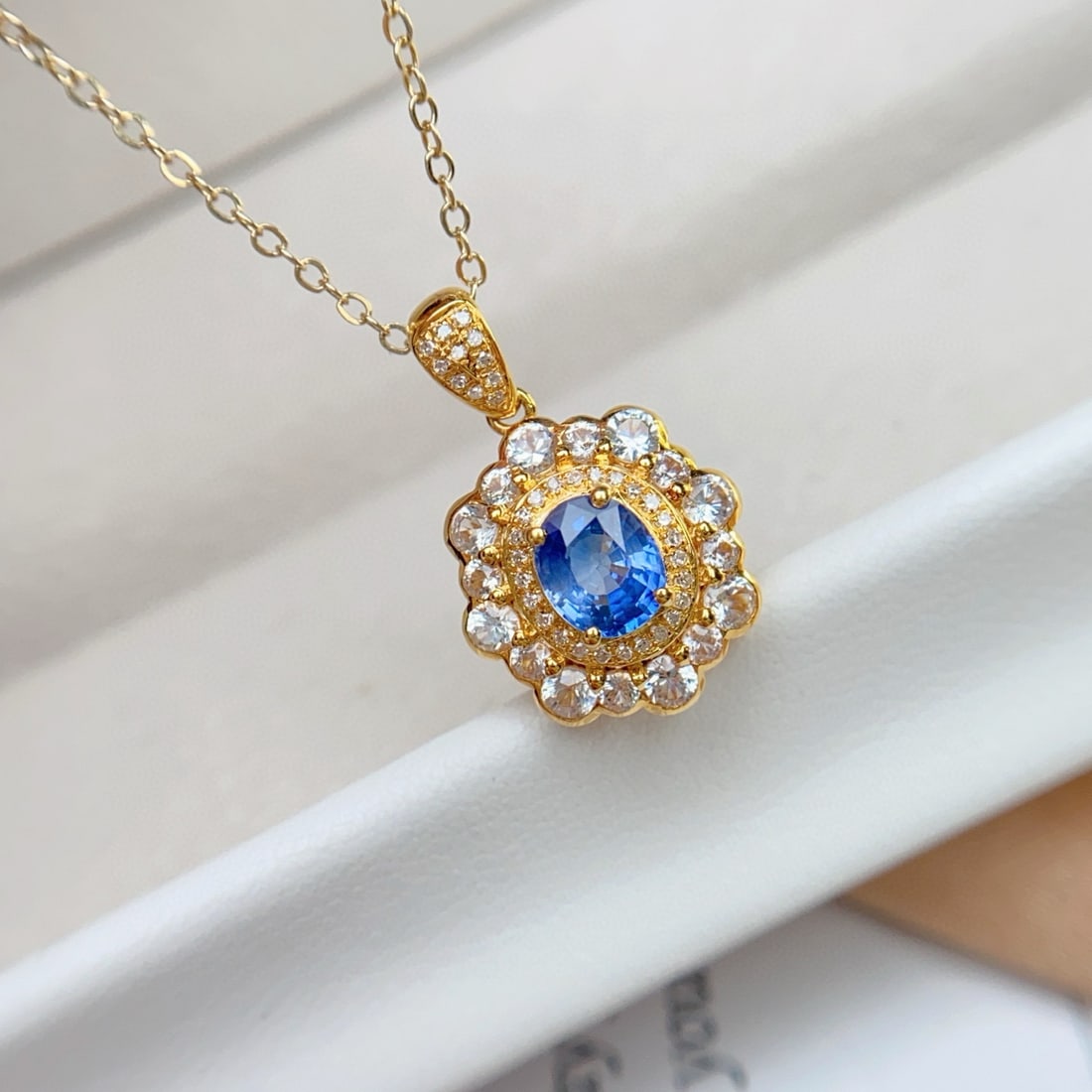 14k Gold 1.00 Ct Natural Sapphire & Diamond & Sapphire Pendant( Without Chain ): Ref:231031075 // gold content:14k gold // main gemstone:sapphire // shape:oval // carat weight:1. 00ct // color:blue // treatment:natural // // adjacent gemstone 2 : diamond // number of stones:37 //