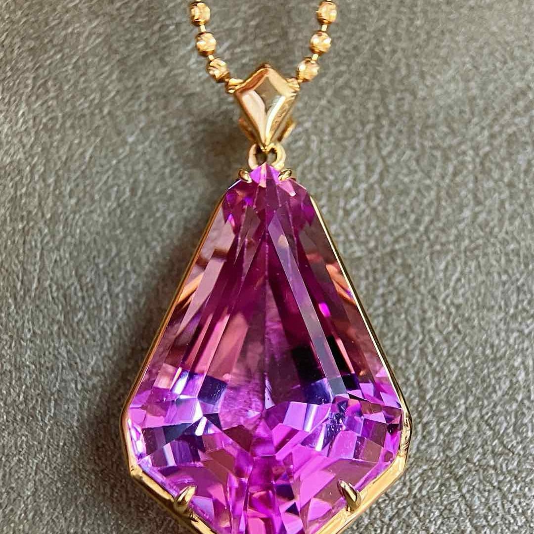 14k Gold 36.71 Ct Natural Kunzite Pendant( Without Chain ): Ref:231032124 // gold content:14k gold // main gemstone:kunzite // shape:other // carat weight:36. 71ct // color:purple // treatment:natural // Condition: New Low Estimate: 7500.00 High Estimate: