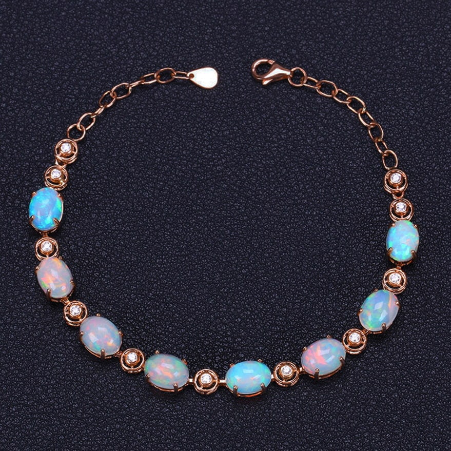 14k Gold 7.08 Ctw Natural Opal & Diamond Bracelet: Ref:231032194 // gold content:14k gold // main gemstone:opal // shape:oval // carat weight:6. 86ct // color:color // treatment:natural // // adjacent gemstone 2 : diamond // shape:round // carat