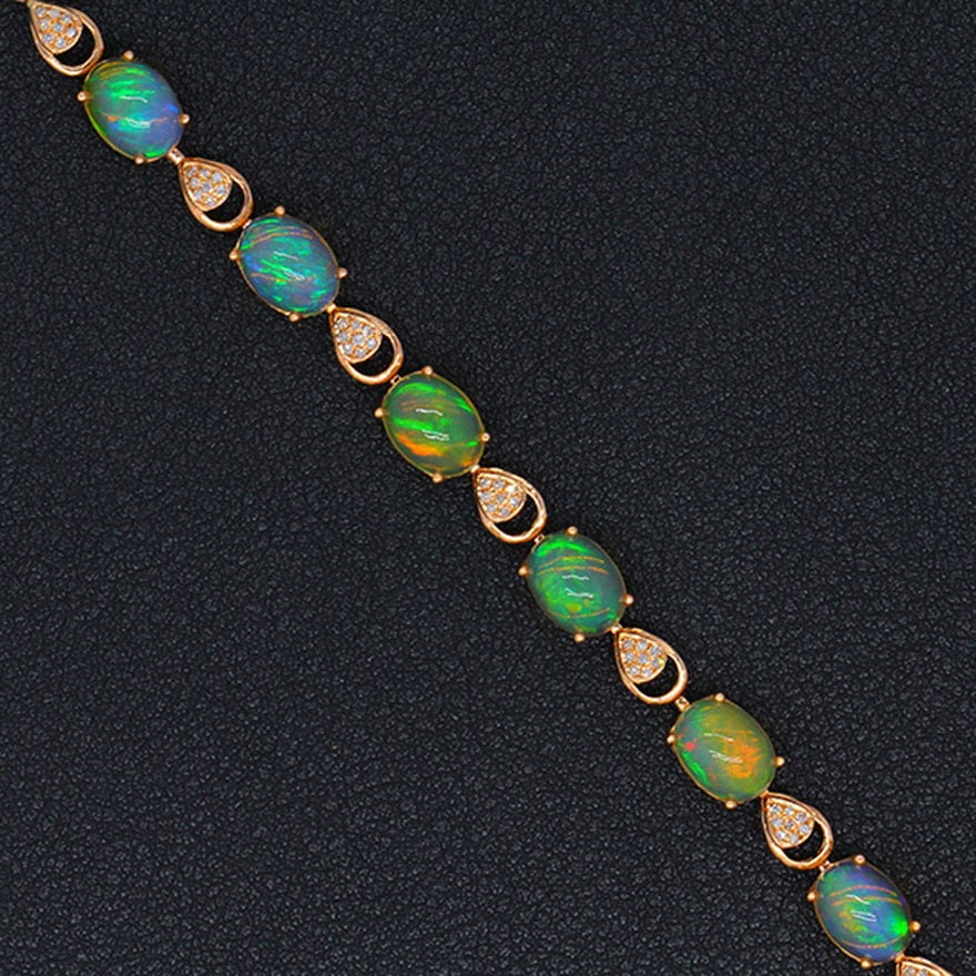 14k Gold 7.02 Ctw Natural Opal & Diamond Bracelet: Ref:231032262 // gold content:14k gold // main gemstone:opal // shape:oval // carat weight:6. 8ct // color:color // treatment:natural // // adjacent gemstone 2 : diamond // shape:round // carat