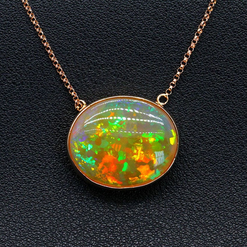 14k Gold 13.6 Ct Natural Opal Necklace: Ref:231032265 // gold content:14k gold // main gemstone:opal // shape:oval // carat weight:13. 6ct // color:color // treatment:natural // Low Estimate: 3700 Condition: New High Estimate: 5600