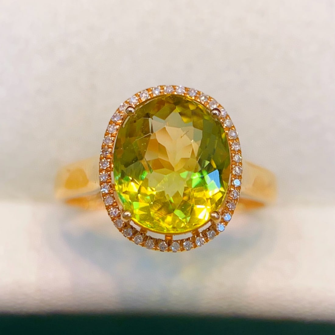 14k Gold 3.8 Ct Natural Tourmaline & Diamond Ring: Ref:231032362 // gold content:14k gold // ring size:7. 25us // // main gemstone:tourmaline // shape:oval // carat weight:3. 8ct // color:yellowish green // treatment:natural // // adjacent gemstone 2