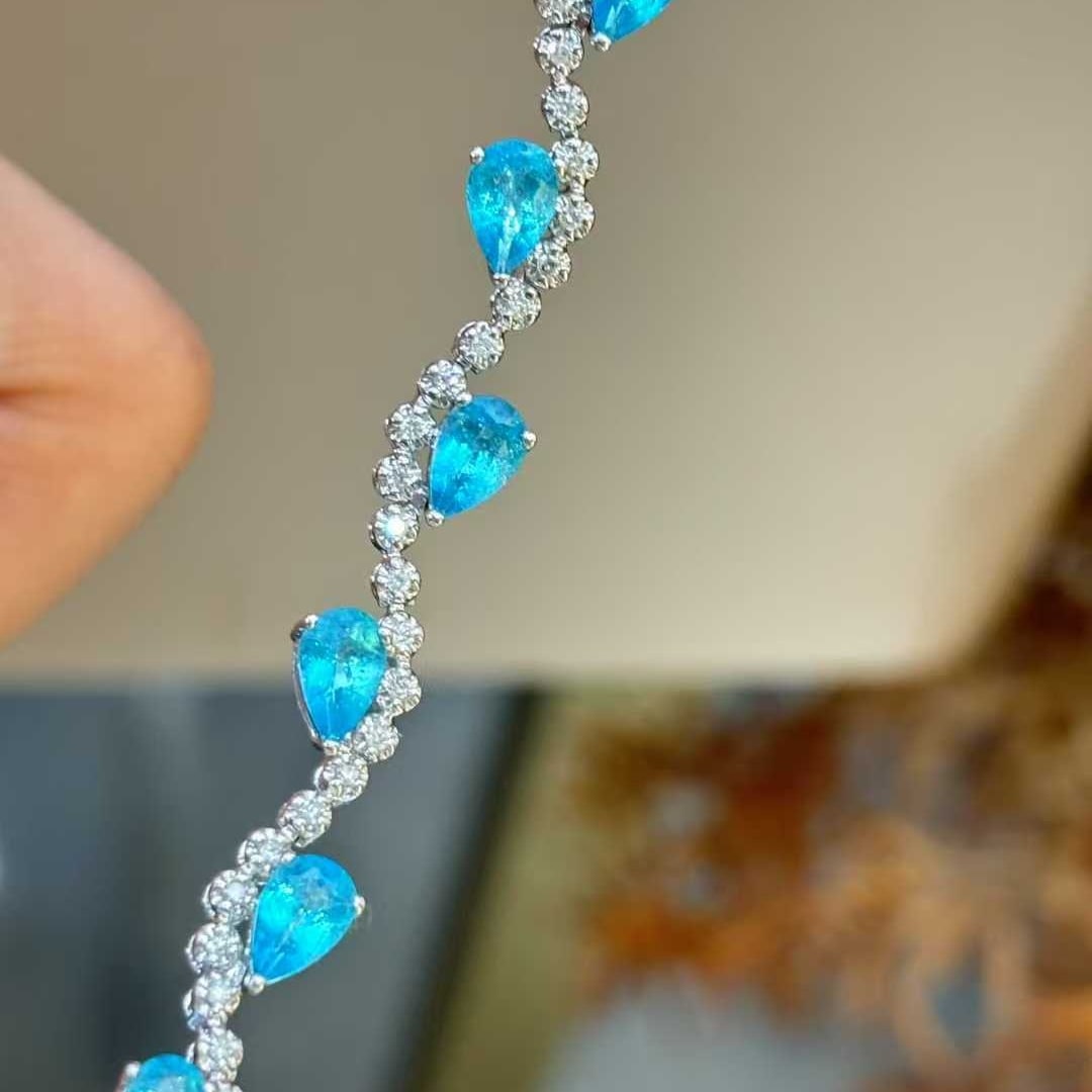 14k Gold 5.3 Ct Natural Paraiba Tourmaline & Diamond Bracelet: Ref:231032369 // gold content:14k gold // main gemstone:paraiba tourmaline // shape:pear // carat weight:5. 3ct // color:blue // treatment:natural // // adjacent gemstone 2 : diamond // shape:round