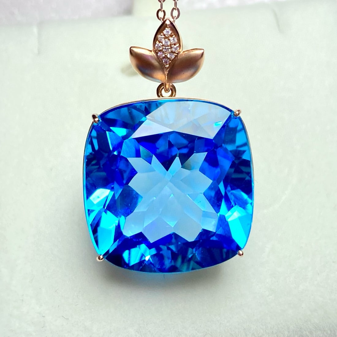 14k Gold 54.9 Ct Natural Topaz & Diamond Pendant( Without Chain ): Ref:231032375 // gold content:14k gold // main gemstone:topaz // shape:cushion // carat weight:54. 9ct // color:blue // treatment:natural // // adjacent gemstone 2 : diamond // number of stones:10 //