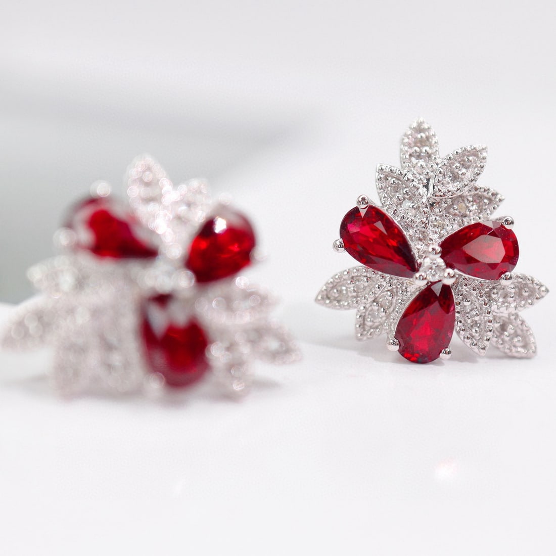 14k Gold 1.79 Ctw Natural Ruby & Diamond Earrings: Ref:231033254 // gold content:14k gold // main gemstone:ruby // shape:pear // carat weight:1. 65ct // color:red // treatment:natural // // adjacent gemstone 2 : diamond // shape:round // carat weight: