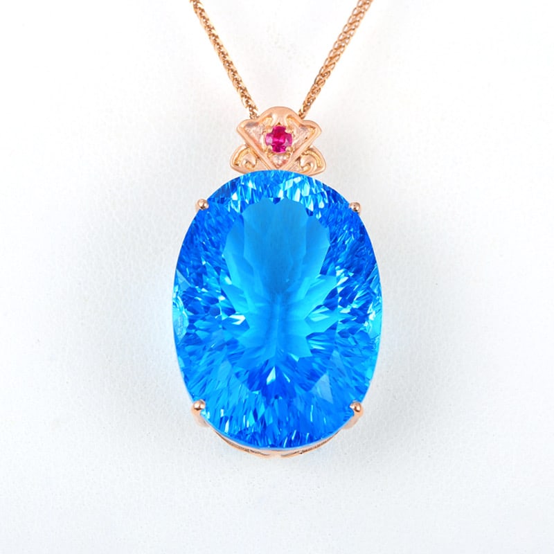 14k Gold 46.38 Ct Natural Topaz & Ruby Pendant( Without Chain ): Ref:231034041 // gold content:14k gold // main gemstone:topaz // shape:oval // carat weight:46. 38ct // color:blue // treatment:natural // // adjacent gemstone 2 : ruby // shape:round // color:red //
