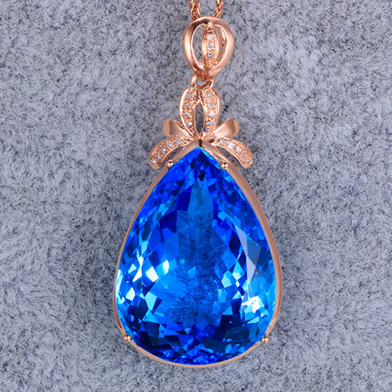 14k Gold 27.11 Ctw Natural Topaz & Diamond Pendant( Without Chain ): Ref:231034100 // gold content:14k gold // main gemstone:topaz // shape:pear // carat weight:27. 05ct // color:blue // treatment:natural // // adjacent gemstone 2 : diamond // shape:round // carat weig