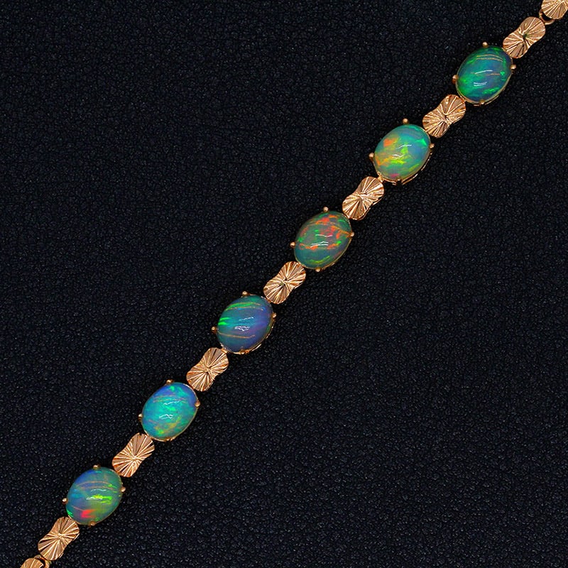 14k Gold 5.32 Ct Natural Opal Bracelet: Ref:231034247 // gold content:14k gold // main gemstone:opal // shape:oval // carat weight:5. 32ct // color:color // treatment:natural // Condition: New Low Estimate: 2400.00 High Estimate: 3600.00