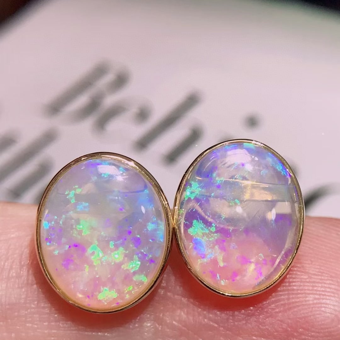 14k Gold 4.1 Ct Natural Opal Earrings: Ref:231036344 // gold content:14k gold // main gemstone:opal // shape:oval // carat weight:4. 1ct // color:color // treatment:natural // High Estimate: 3300 Low Estimate: 2200 Condition: New