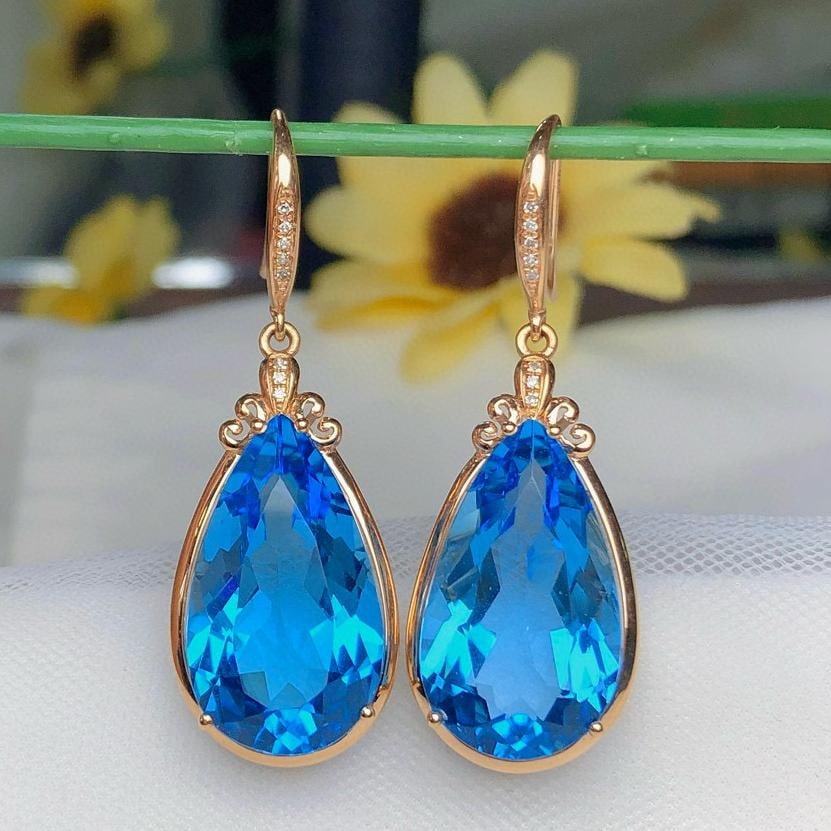 14k Gold 28.6 Ct Natural Topaz & Diamond Earrings: Ref:231037093 // gold content:14k gold // main gemstone:topaz // shape:pear // carat weight:28. 6ct // color:blue // treatment:natural // // adjacent gemstone 2 : diamond // number of stones:16 //