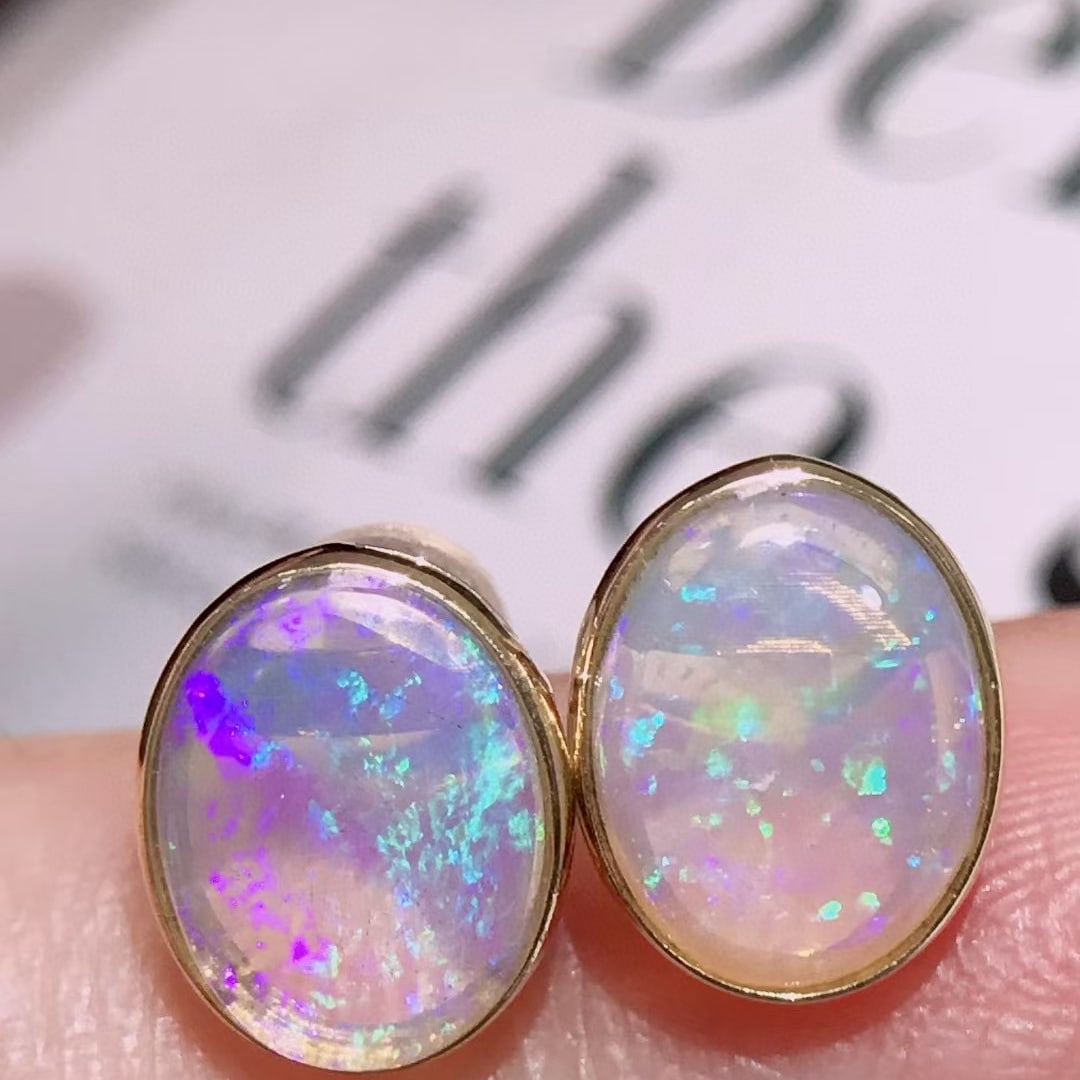 14k Gold 2.3 Ct Natural Opal Earrings: Ref:231038035 // gold content:14k gold // main gemstone:opal // shape:oval // carat weight:2. 3ct // color:color // treatment:natural // Condition: New Low Estimate: 1700.00 High Estimate: 2500.00