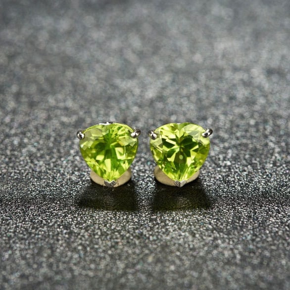 14k Gold 3.06 Ct Natural Peridot Earrings: Ref:231038165 // gold content:14k gold // main gemstone:peridot // shape:heart // carat weight:3. 06ct // color:green // treatment:natural // Condition: New Low Estimate: 1300.00 High Estimate: 2000.0