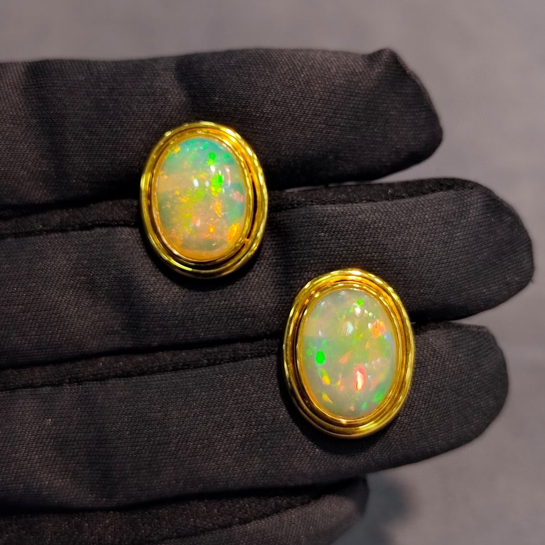 14k Gold 6.43 Ct Natural Opal Earrings: Ref:231038283 // gold content:14k gold // main gemstone:opal // shape:oval // carat weight:6. 43ct // color:color // treatment:natural // Condition: New Low Estimate: 3100.00 High Estimate: 4600.00
