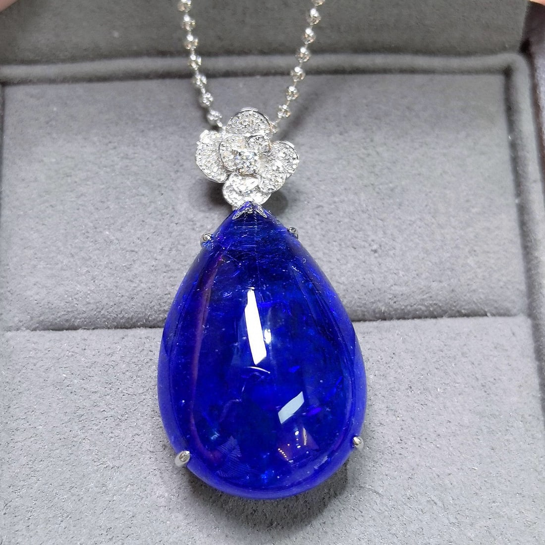 14k Gold 46.60 Ctw Natural Tanzanite & Diamond Pendant( Without Chain ): Ref:231038343 // gold content:14k gold // main gemstone:tanzanite // shape:pear // carat weight:46. 39ct // color:blue // treatment:natural // // adjacent gemstone 2 : diamond // shape:round // carat