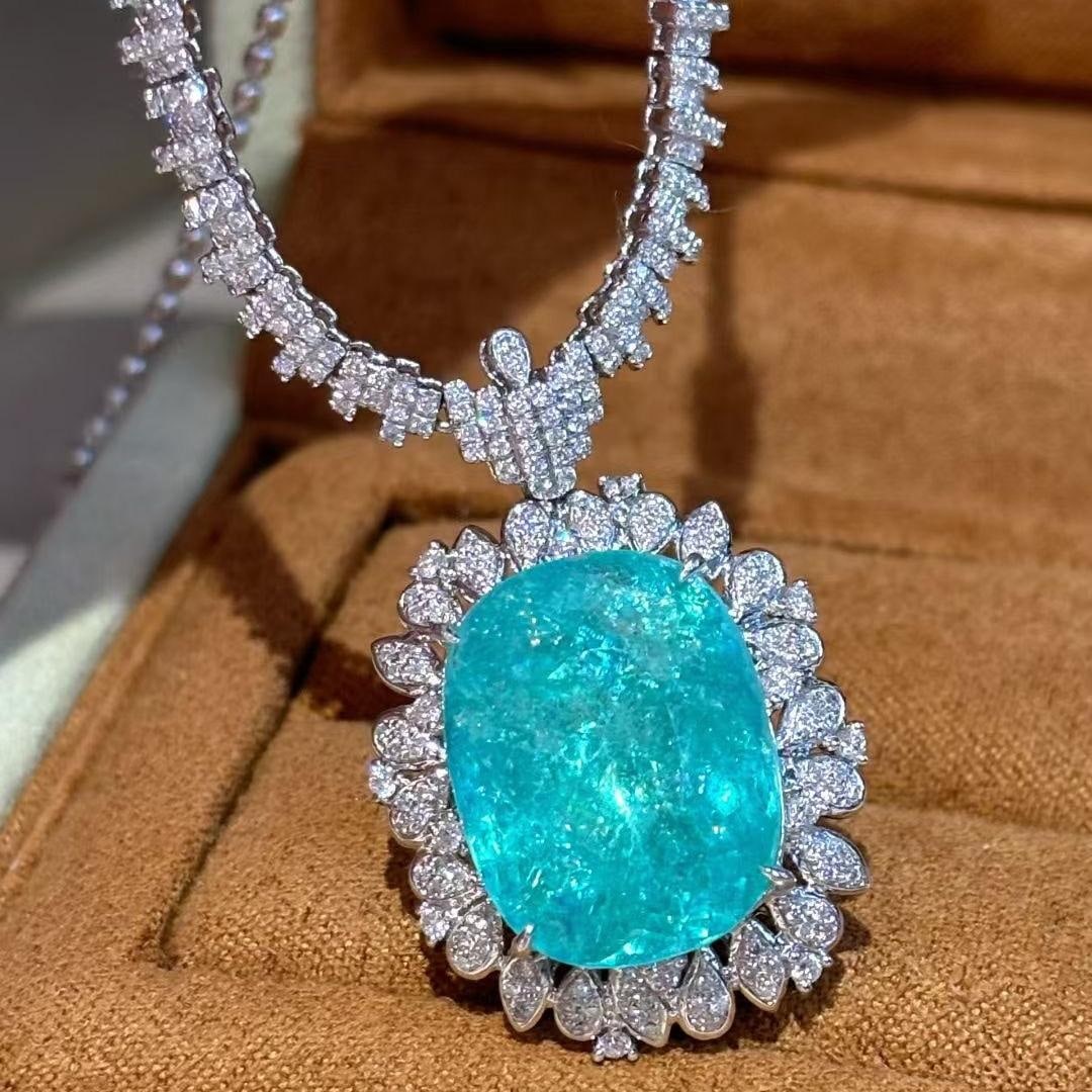 14k Gold 15 Ct Natural Paraiba Tourmaline & Diamond Necklace: Ref:231039090 // gold content:14k gold // main gemstone:paraiba tourmaline // shape:cushion // carat weight:15ct // color:neon blue // treatment:natural // // adjacent gemstone 2 : diamond // shape:ro