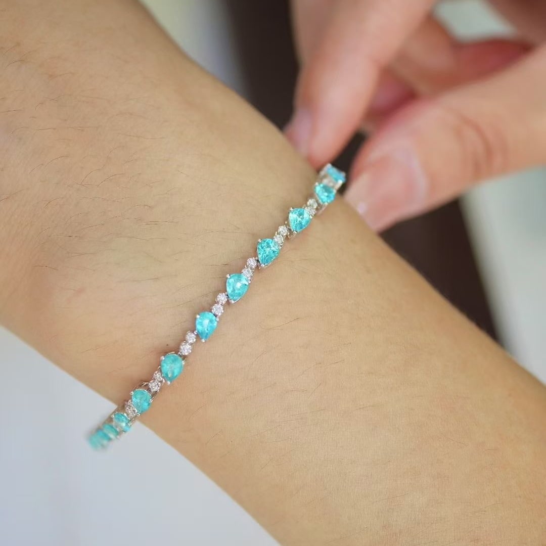 14k Gold 4.05 Ct Natural Paraiba Tourmaline & Diamond Bracelet: Ref:231040387 // gold content:14k gold // main gemstone:paraiba tourmaline // shape:pear // carat weight:4. 05ct // color:blue // treatment:natural // // adjacent gemstone 2 : diamond // shape:round /