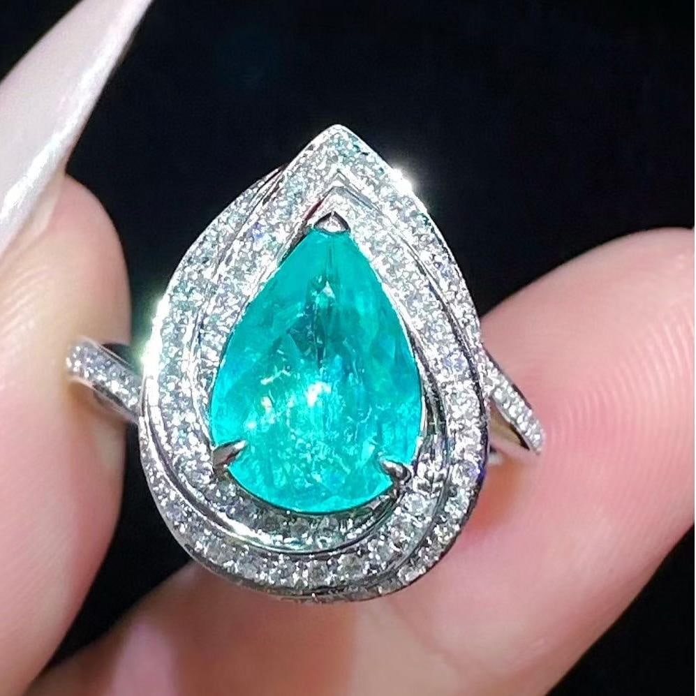 14k Gold 1.44 Ctw Natural Paraiba Tourmaline & Diamond Ring: Ref:231043011 // gold content:14k gold // ring size:7. 25us // // main gemstone:paraiba tourmaline // shape:pear // carat weight:1. 1ct // color:blue // treatment:natural // // adjacent gemstone 2 :