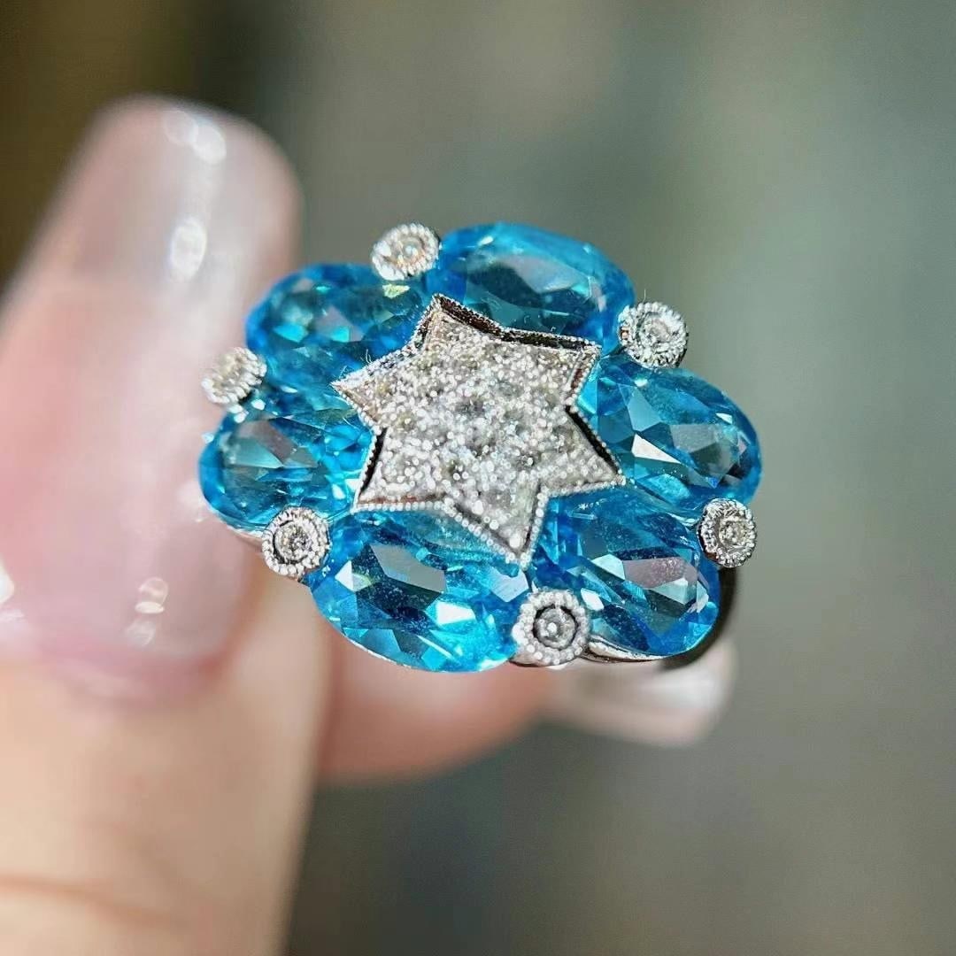 14k Gold 7.47 Ctw Natural Topaz & Diamond Ring: Ref:231043104 // gold content:14k gold // ring size:7. 25us // // main gemstone:topaz // shape:oval // carat weight:7. 27ct // color:blue // treatment:natural // // adjacent gemstone 2 : diamond //