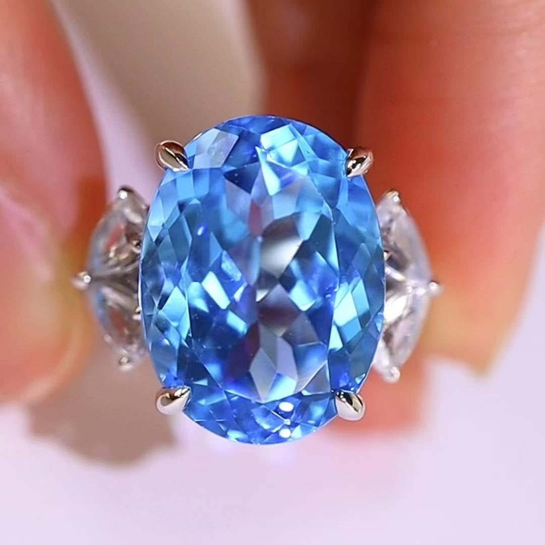 14k Gold 14.21 Ctw Natural Topaz & Sapphire Ring: Ref:231043105 // gold content:14k gold // ring size:7. 25us // // main gemstone:topaz // shape:oval // carat weight:12. 77ct // color:blue // treatment:natural // // adjacent gemstone 2 : sapphire // 