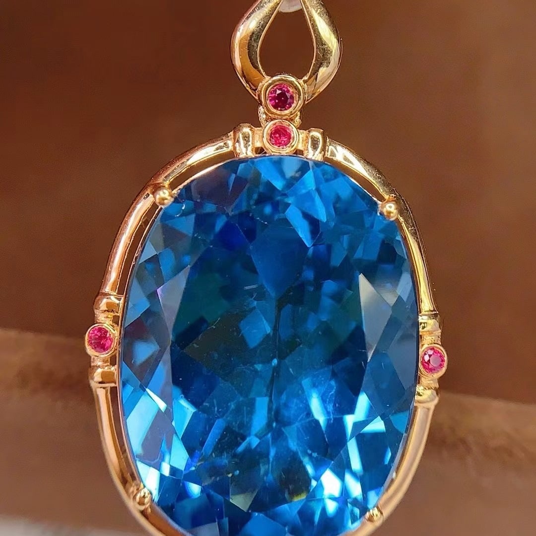 14k Gold 19.1 Ct Natural Topaz & Ruby Pendant( Without Chain ): Ref:231043145 // gold content:14k gold // main gemstone:topaz // shape:oval // carat weight:19. 1ct // color:blue // treatment:natural // // adjacent gemstone 2 : ruby // number of stones:5 // shape:r