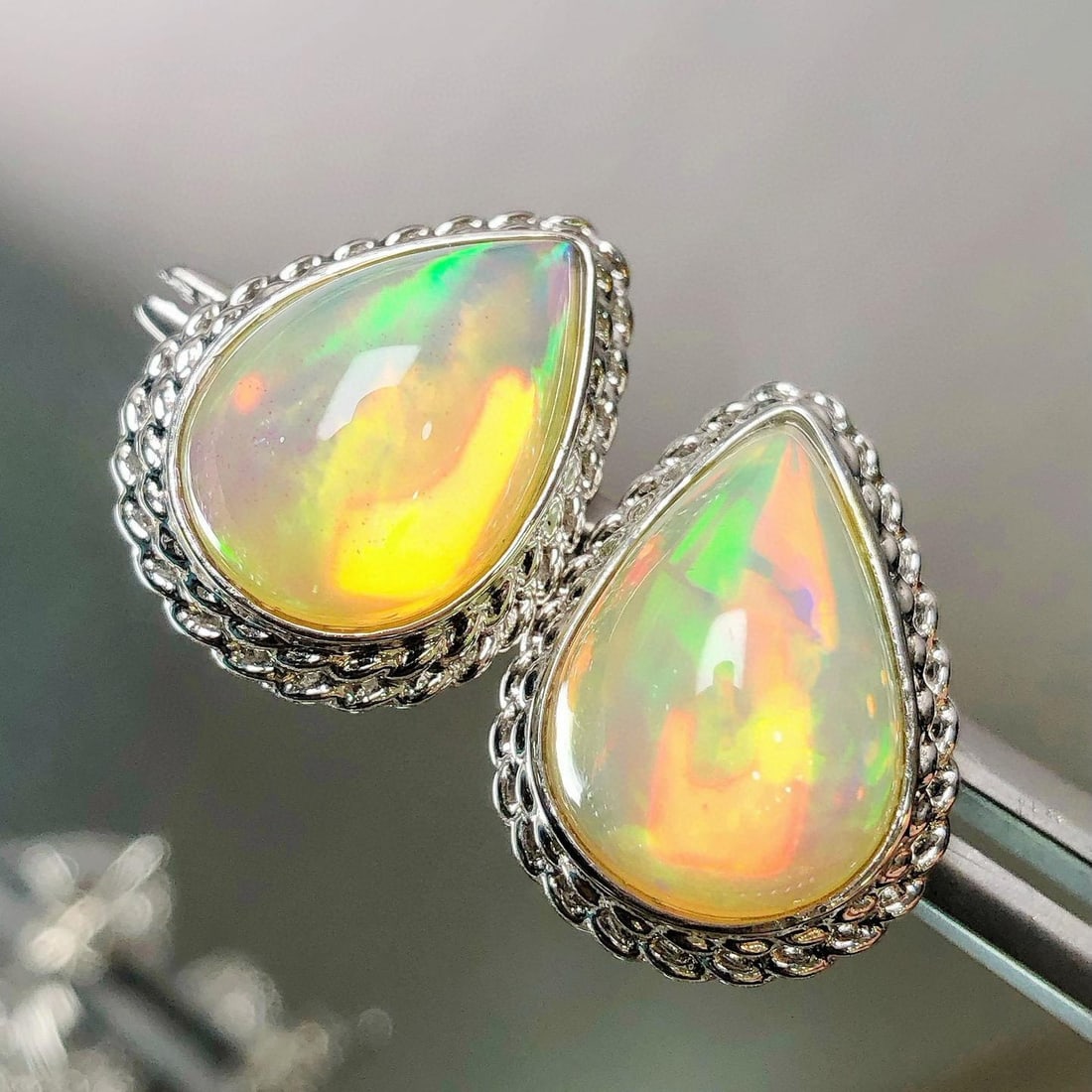 14k Gold 5.90 Ct Natural Opal Earrings: Ref:231043203 // gold content:14k gold // main gemstone:opal // shape:pear // carat weight:5. 90ct // color:color // treatment:natural // Condition: New Low Estimate: 2600.00 High Estimate: 4000.00