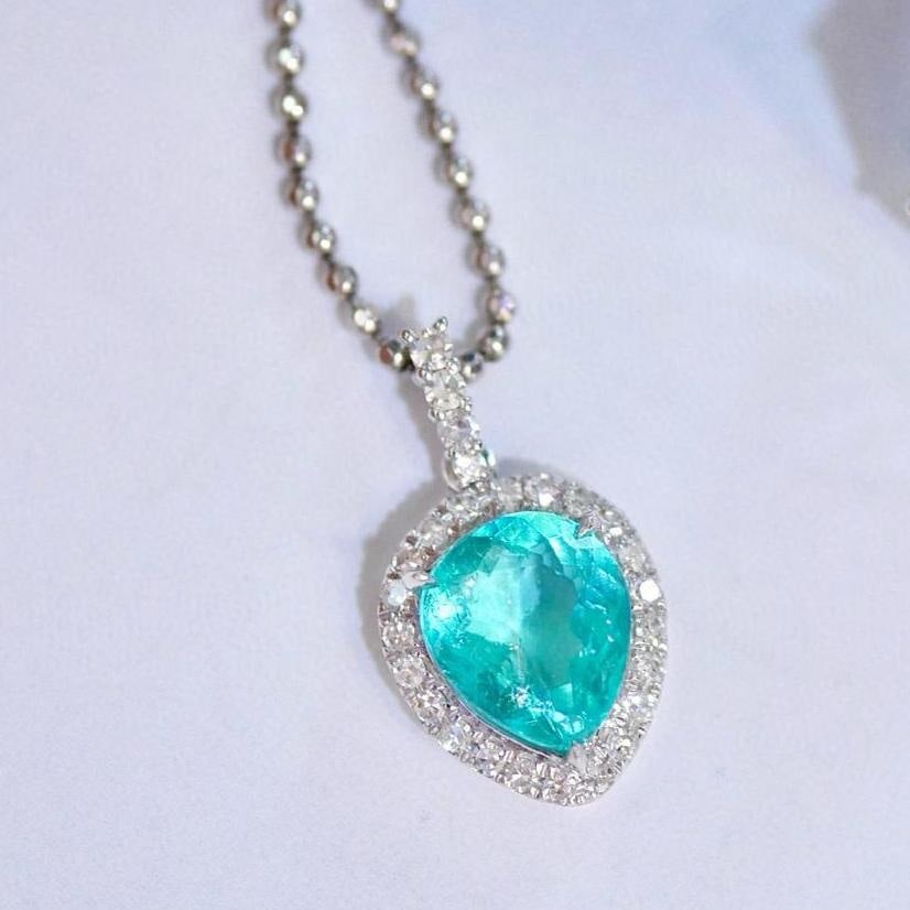 14k Gold 0.96 Ctw Natural Paraiba Tourmaline & Diamond Pendant( Without Chain ): Ref:231043212 // gold content:14k gold // main gemstone:paraiba tourmaline // shape:pear // carat weight:0. 85ct // color:blue // treatment:natural // // adjacent gemstone 2 : diamond // shape:round /