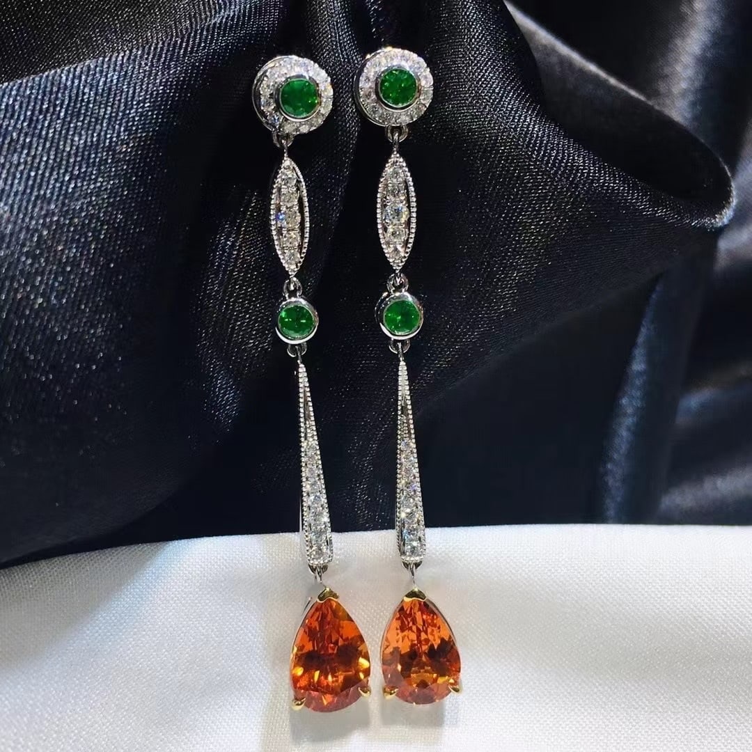 14k Gold 4.81 Ctw Natural Spessartine & Diamond Earrings: Ref:231044415 // gold content:14k gold // main gemstone:spessartine // shape:pear // carat weight:4. 5ct // color:orange // treatment:natural // // adjacent gemstone 2 : diamond // shape:round // cara