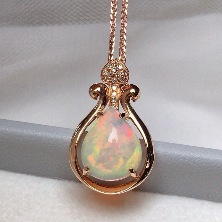 14k Gold 2.10 Ct Natural Opal & Diamond Pendant( Without Chain ): Ref:231043075 // gold content:14k gold // main gemstone:opal // shape:pear // carat weight:2. 10ct // color:color // treatment:natural // // adjacent gemstone 2 : diamond // number of stones:15 //