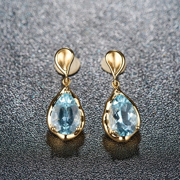 14k Gold 3.42 Ct Natural Aquamarine Earrings: Ref:231044075 // gold content:14k gold // main gemstone:aquamarine // shape:pear // carat weight:3. 42ct // color:santa maria color // treatment:natural // Condition: New Low Estimate: 2900.00 High Es