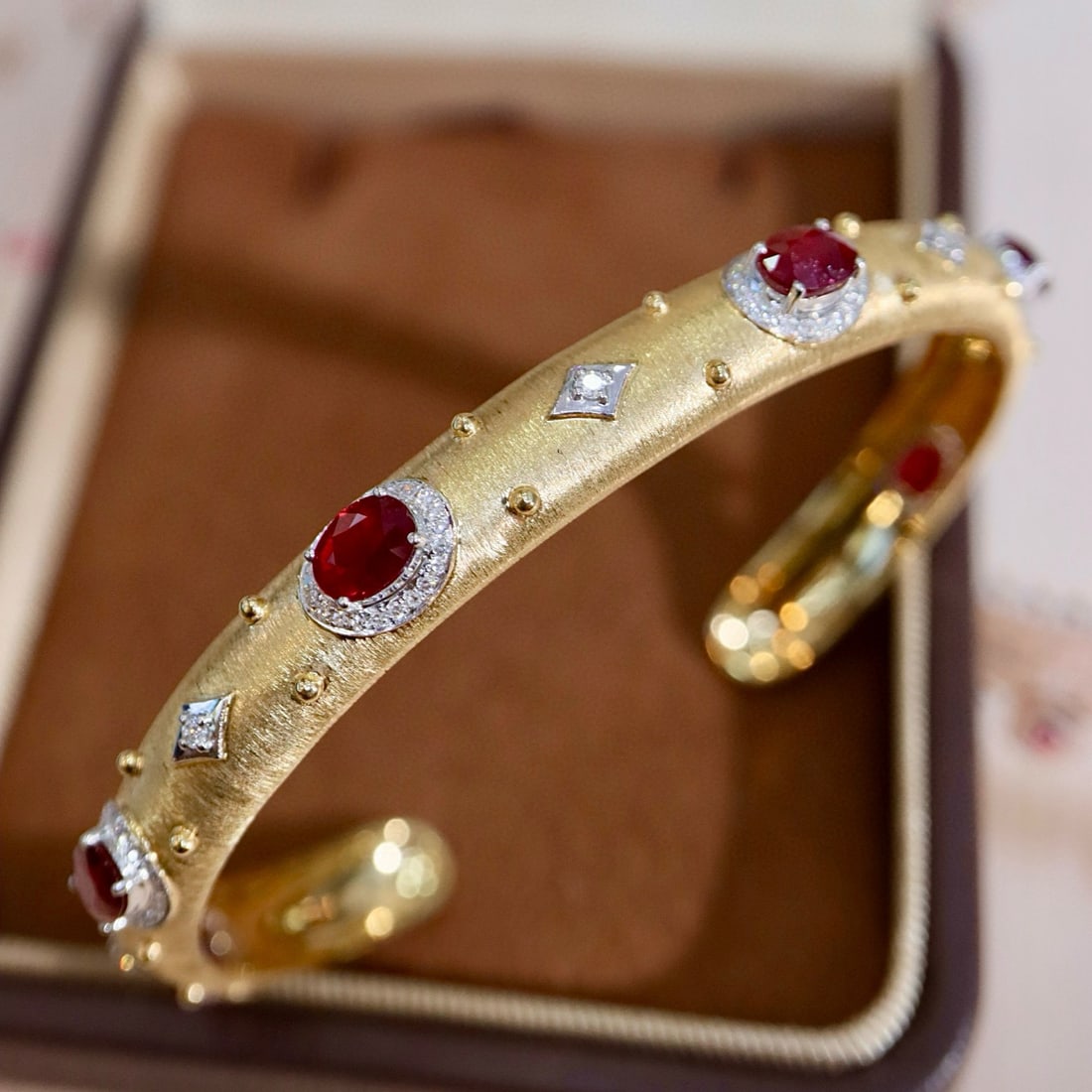 14k Gold 3.55 Ctw Natural Ruby & Diamond Bangle: Ref:231045102 // gold content:14k gold // main gemstone:ruby // shape:oval // carat weight:3. 15ct // color:red // treatment:natural // // adjacent gemstone 2 : diamond // shape:round // carat weight: